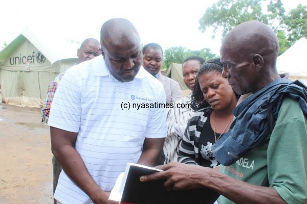 Hands-on: Mashanda being briefed by  a local relief officer on the situation