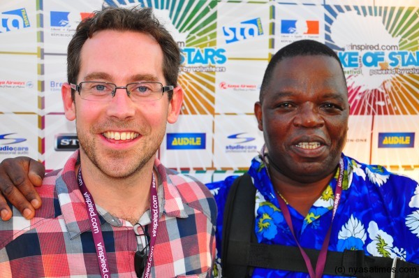 Will Jameson posing with Malawi Finance Minister Ken Lipenga at Lake of Stars