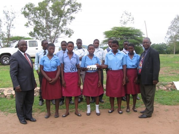 Mwalwanda with some students who have benefted from the donation