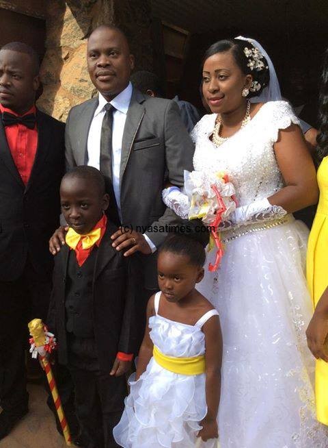 Happy day: The new Mr and Mrs Mwanoka exit the Mtiwa Woyera catholic  church after their nuptials in Lilongwe
