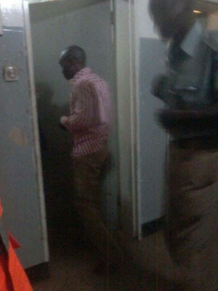 Mwase being led into a cell at Kawale Police