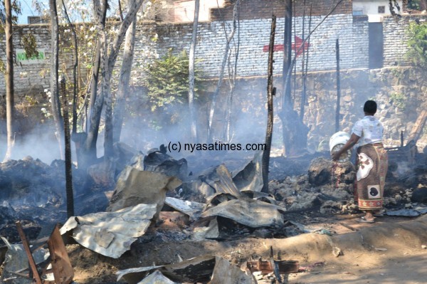 The razed down furniture shops and attempts to put the fire off---Photo by James Chimpweta, NPL 