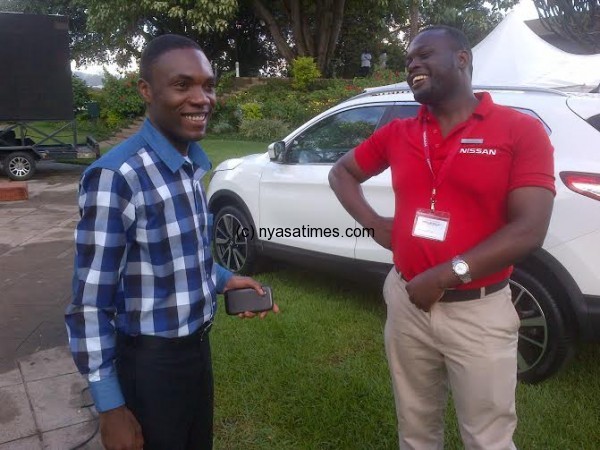  Assima shares a light moment with Mbawala, Marketing & Sales Manager, Nissan Malawi