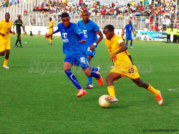  Gerald Papa Phiri chasing for the ball as a Tigers defender trying to passs through him.--Photo Jeromy Kadewere