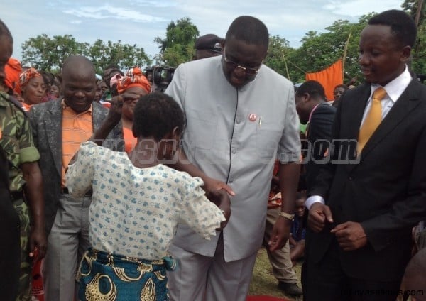 Vice President Kachali greets a victim of flood before making donation of relief items