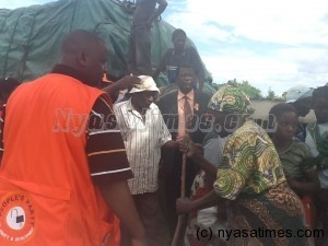 Getting the community back on its feet: Mtonga presents relief items to Karonga hailstorm victims from President Joyce Banda