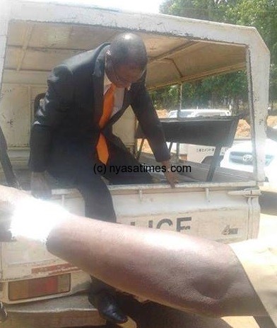 Kasambara: Stepping out of police car when he was  arrested 