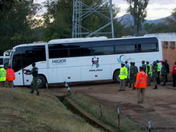 Flames bus under police escort.-Photo by Jeromy Kadewere/Nyasa Times