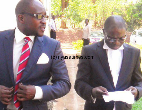 Lawyers : Kasambara (right) with his client in cashgate, another lawyer Tukula 