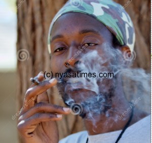 Rastafarian man smoking cannabis