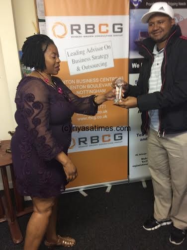 Martha Nkhoma presents an award to winner