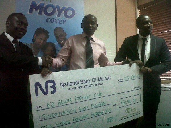 TNM presenting a cheque to Bullets secretary Higger Mkandawire