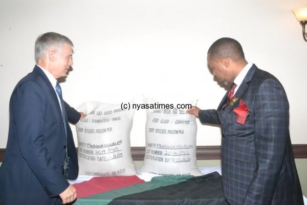 President Chilima and Bergvinson admire the 50 kg bags of the pegion peas