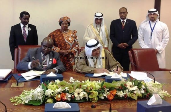 Deputy Minister of Finance Dr. Cornelius Mwalanda and Kuwait Fund Director General Abdulwahab Al Bader sign the historic agreement