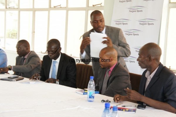 Sponsors and league administrators in a deal signing ceremony