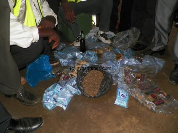 Lilongwe stewards showing chamba (in black plastic bag) and beer sachets confiscated at Civo Stadium 