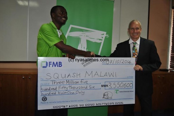 Ngwenya presents a TNM cheque to Squash body