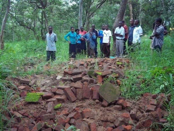 Villagers showing the destroyed tombstones 