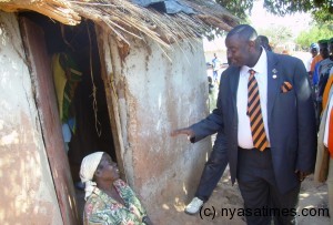 Mtonga informing the woman that she will  have good house nder President Joyce Banda's Mudzi Trust