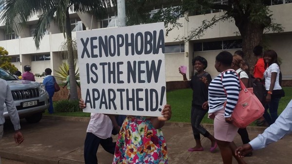 The writting on the placard is clear: Xenophobia is the new apartheid