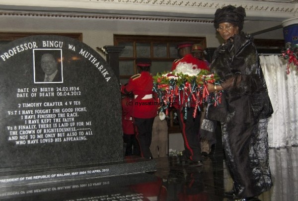 Malawi's President Banda lays a wreath during a funeral service for late president Mutharika on his farm in his home village of Chisoka