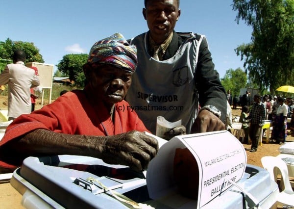 A senior citizen voting in national elections