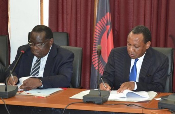 Finance Minister Gondwe with FDH Bank boss Thom Mpinganjira at signing the Malawi Savings Bank controversial deal