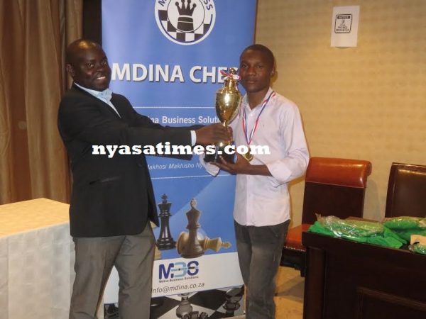 Phiri receives the trophy from the sponsors