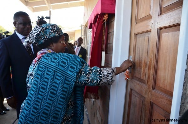 The President opens one the houses at Chilumba Barracks to mark the handover of the 100 houses