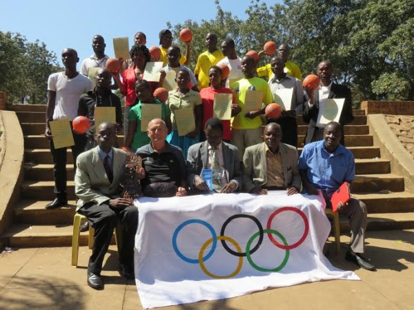 The participants pose for a group photo with the instructor and other officials.